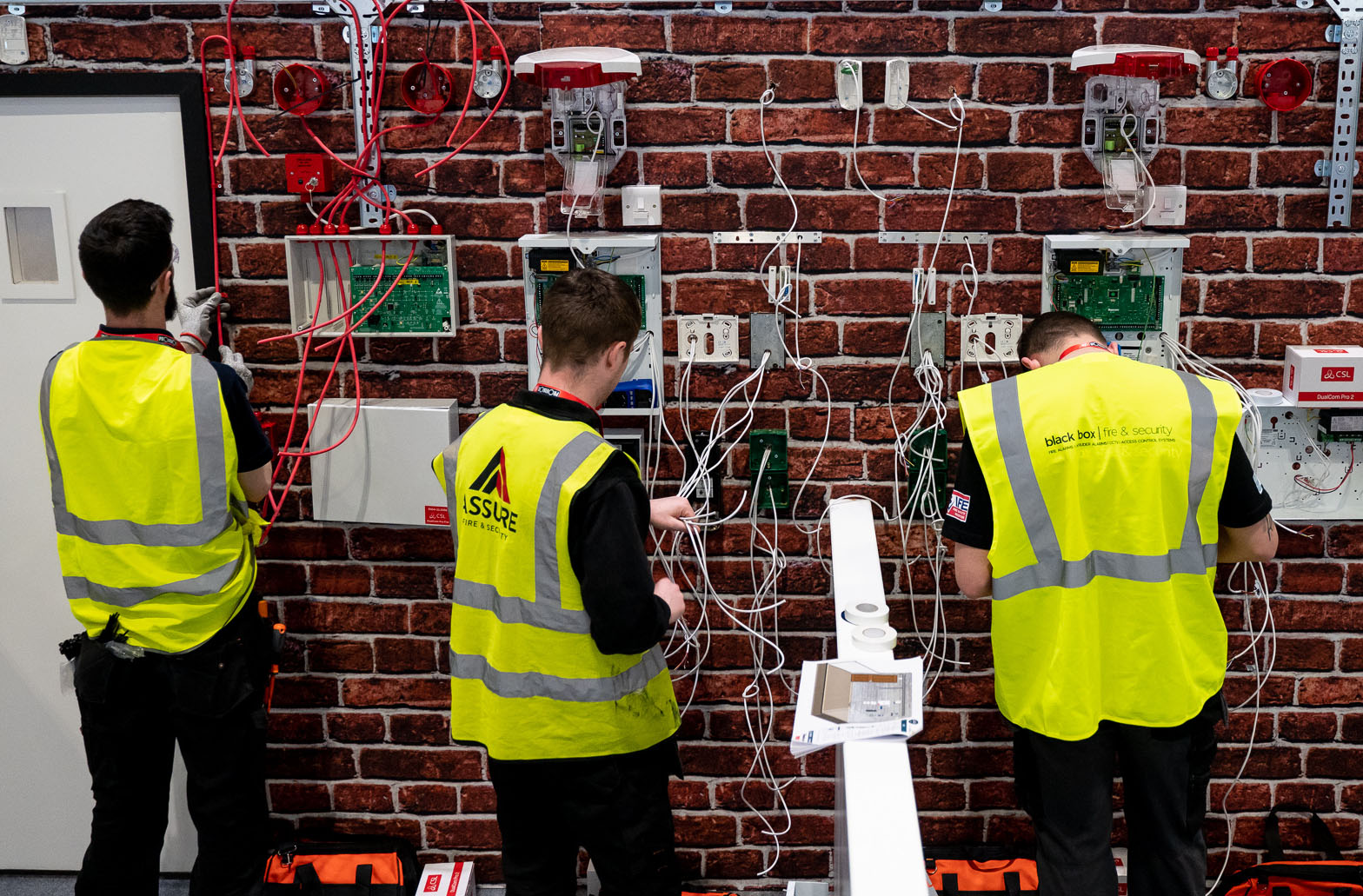 Three engineer students practising their skills.