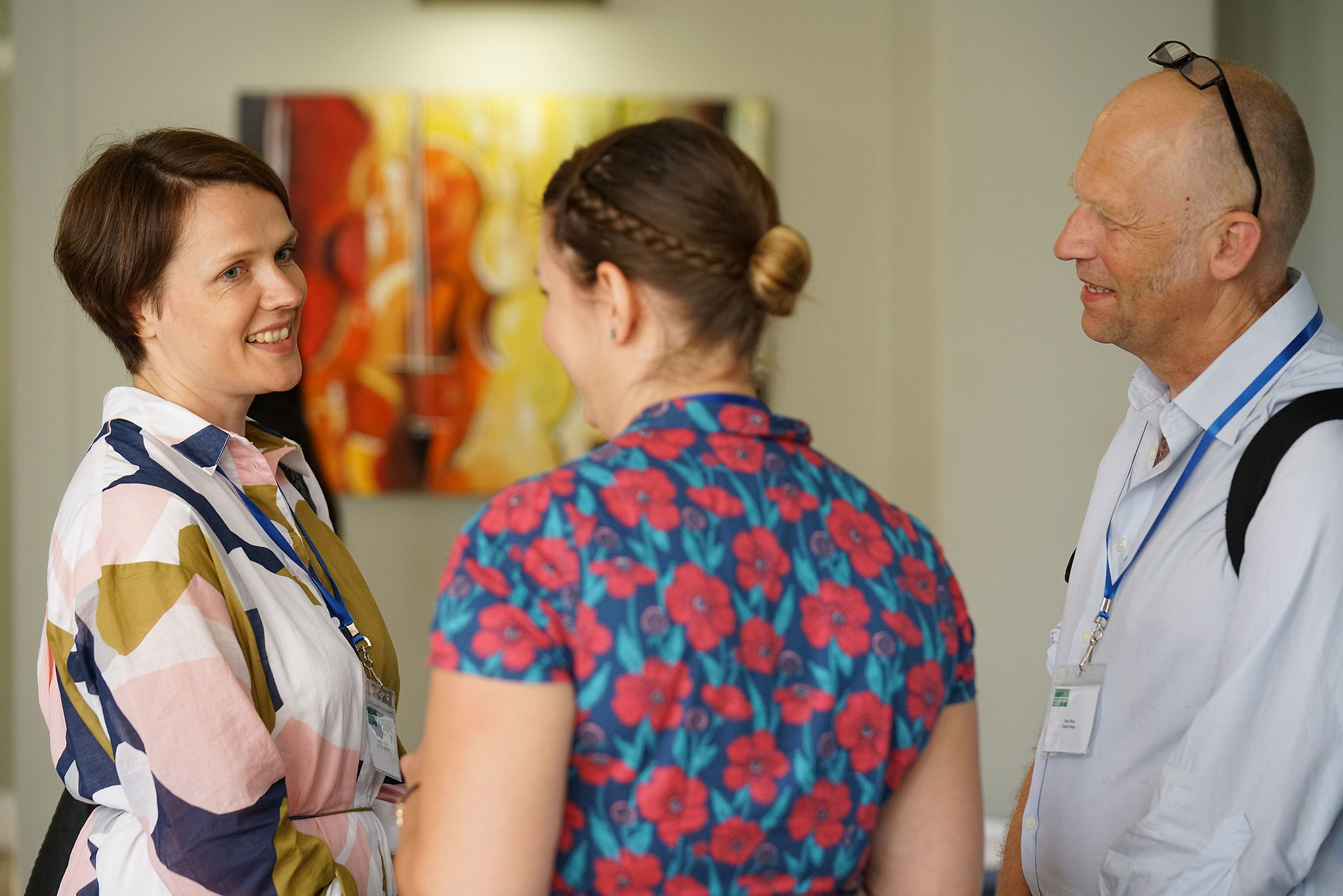 Group of three teachers chatting at an event