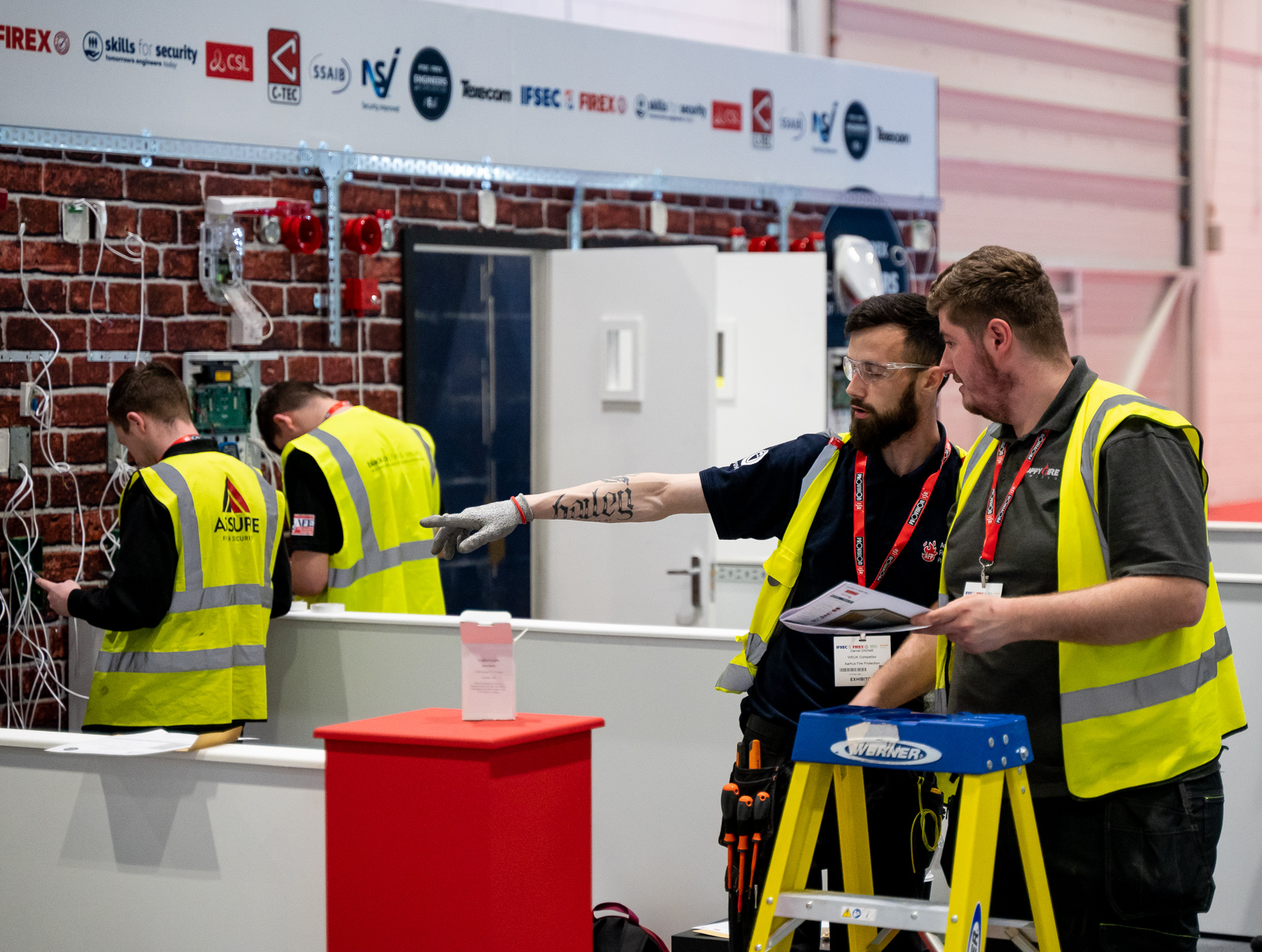 Two engineer professionals having a conversation in a practical learning environment.