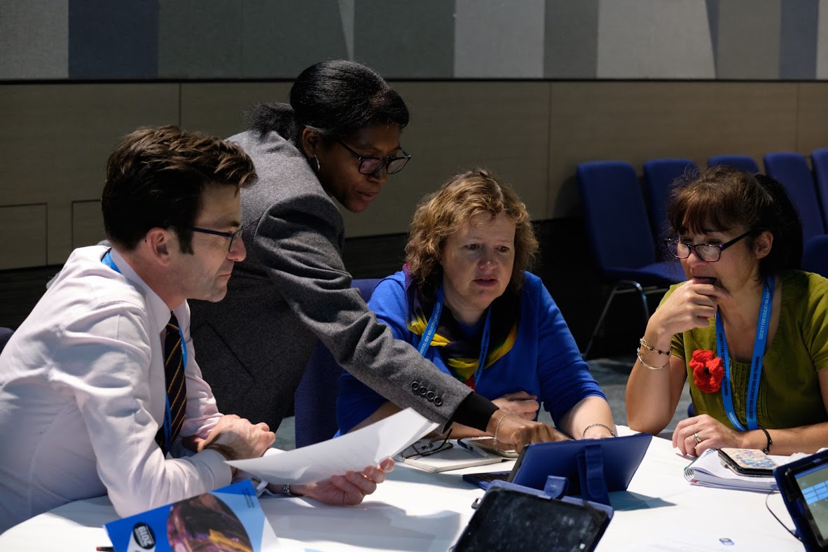 Group Being Helped By Workshop Host At SET Conference