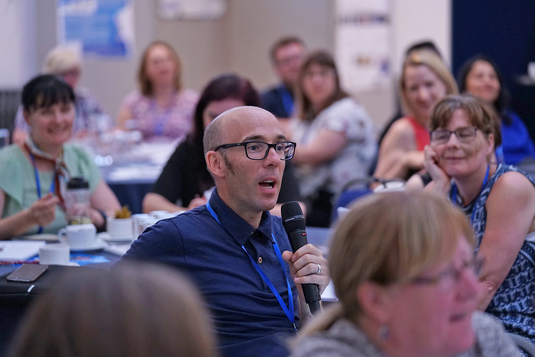 Audience member at an event speakign with microphone