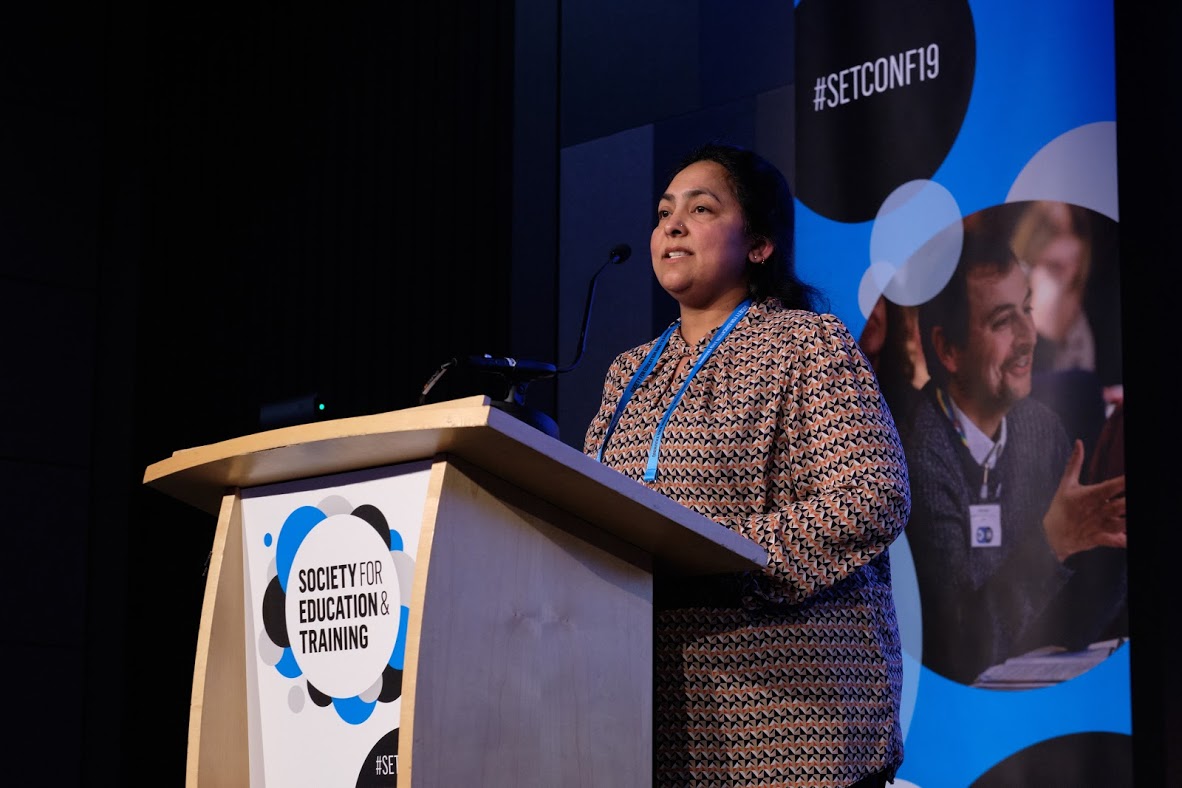 Female Speaker At Podium At SET Conference