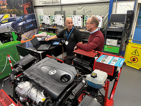 Men having conversation next to an engine