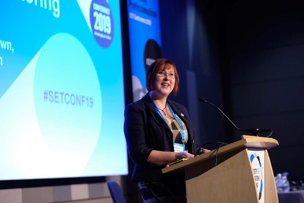 Female Speaker At Podium At SET Conference